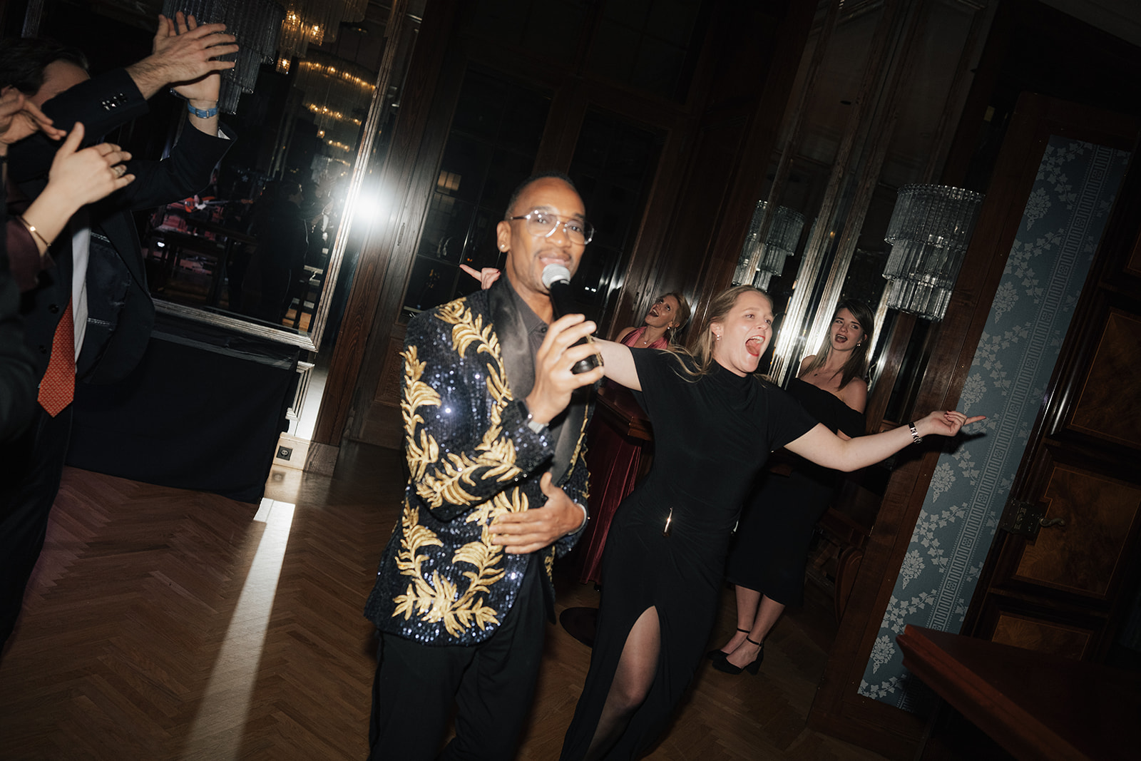 Live singer performing on the dance floor during a wedding party at Park Hyatt Vienna, guests dancing and celebrating in an elegant historic ballroom.