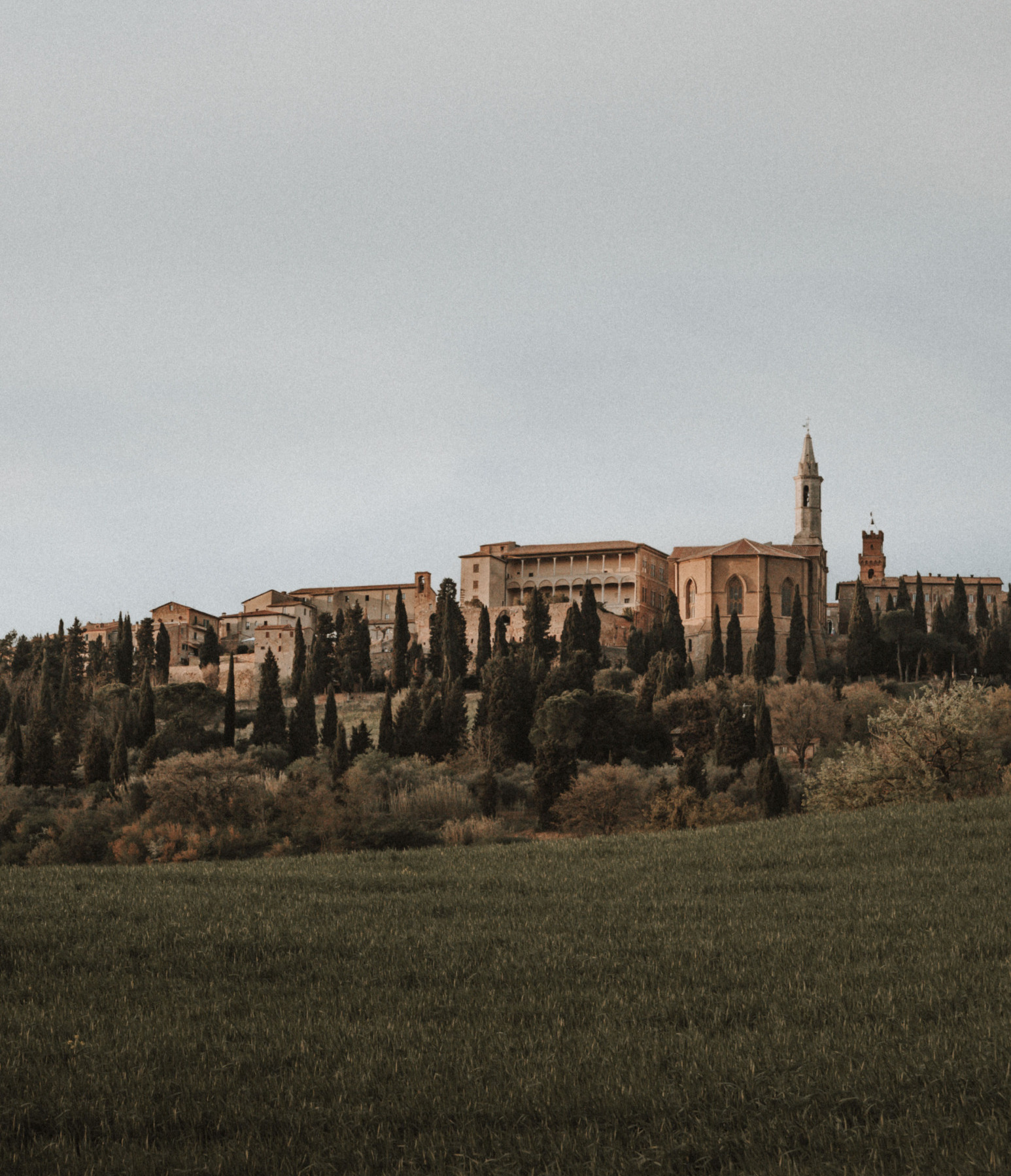 Historic Tuscan town with monastery and cypress trees in Val d’Orcia, Italy wedding location
