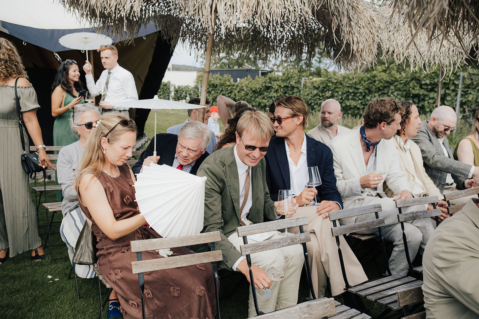 Wedding guests laughing and celebrating together in the garden at Franz von Grün