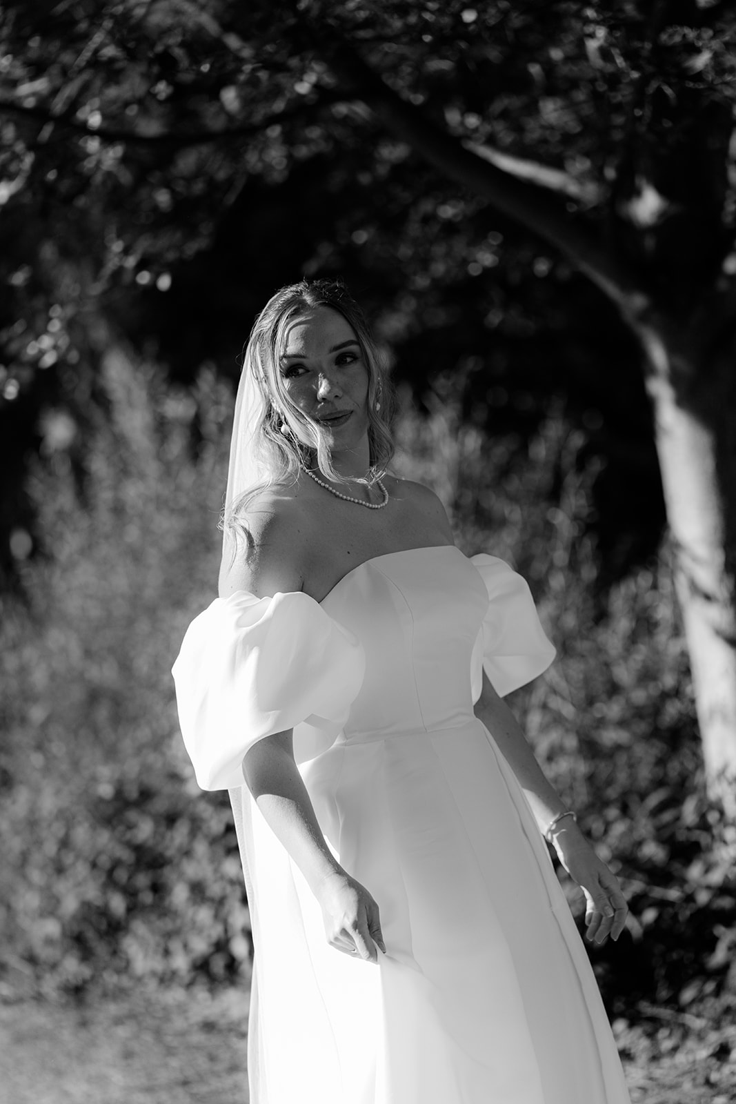 Black and white portrait of a bride in a garden at a wedding at Mattsee near Salzburg
