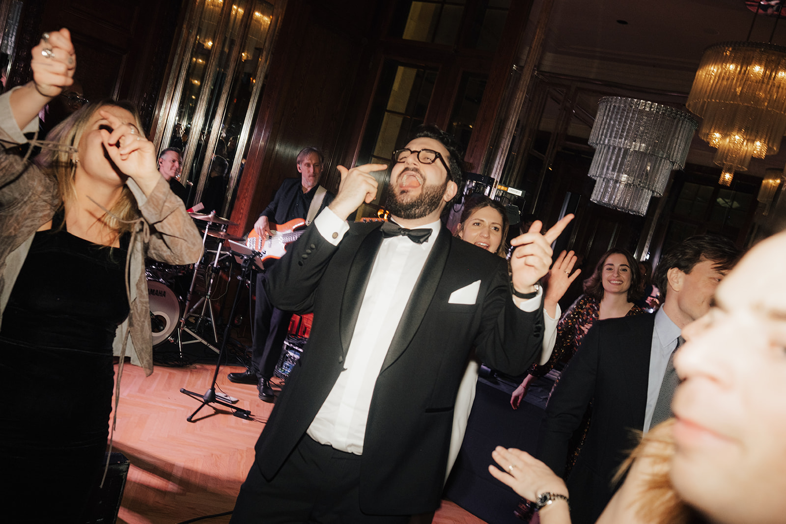 Groom singing with friends on the dance floor at a wedding party at Park Hyatt Vienna