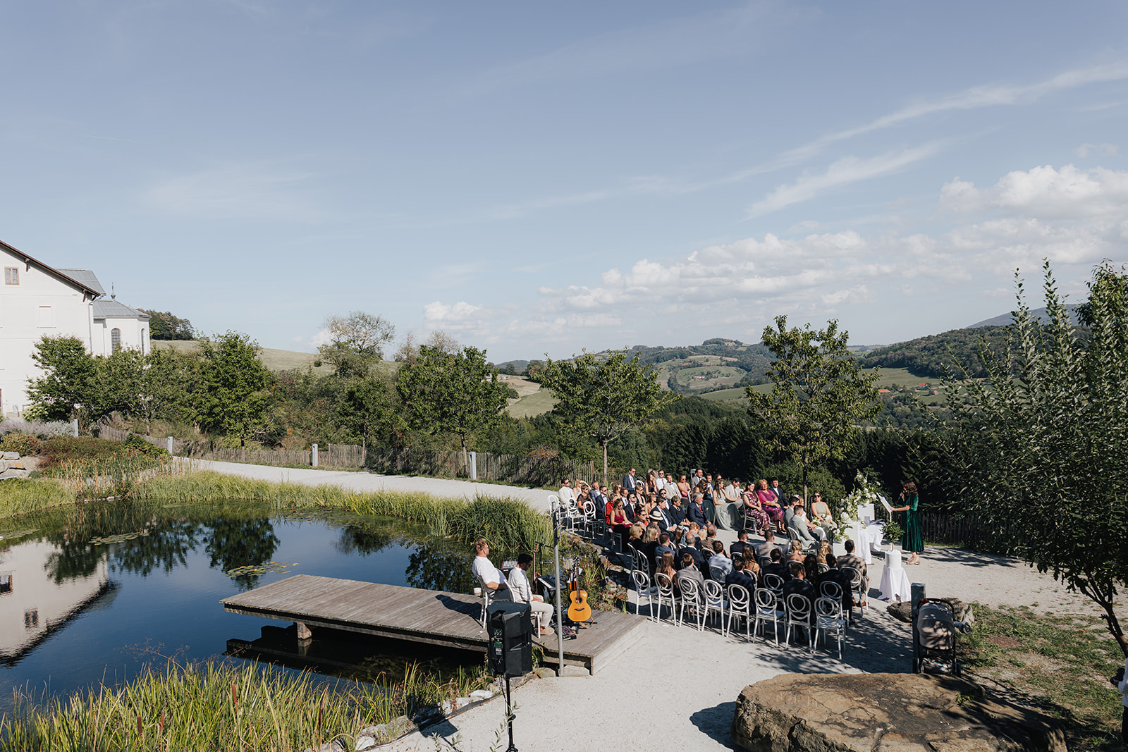 Outdoor wedding ceremony by the pond at Refugium Hochstrass in the Vienna Woods, Lower Austria