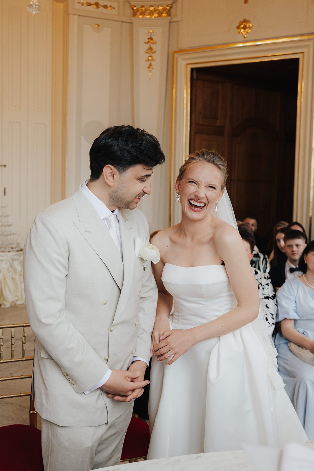 Bride and groom laughing during their civil wedding ceremony at the Upper Belvedere in Vienna